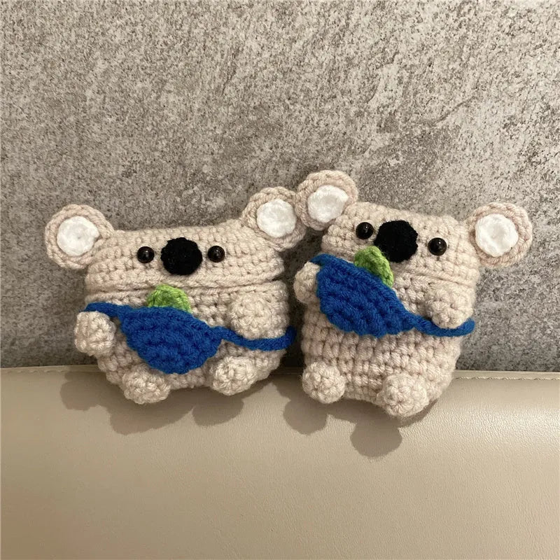 Handmade knitted koala bear backpack design cover on an AirPods case.