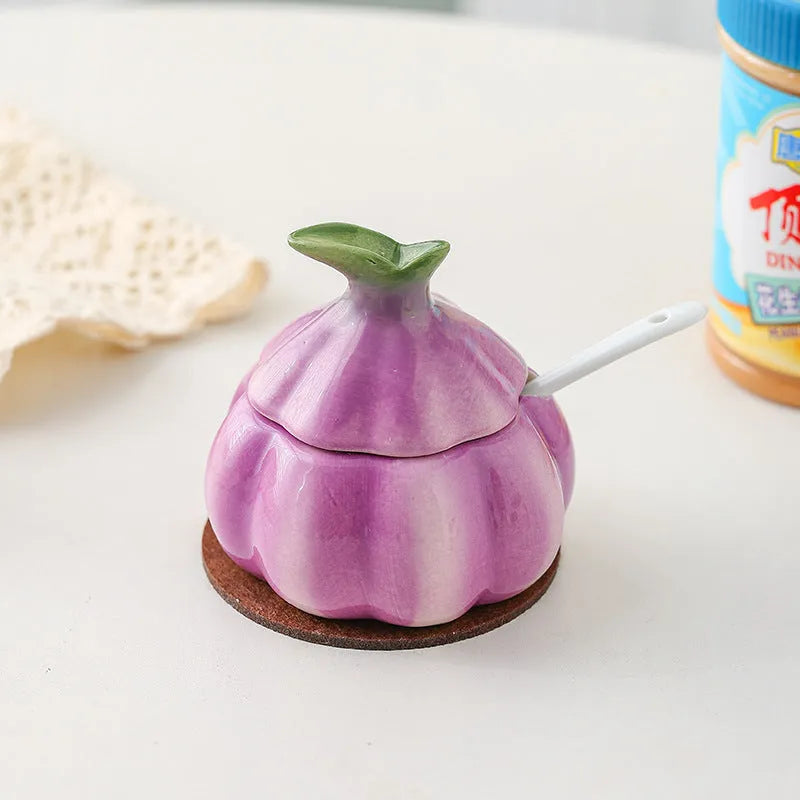 Ceramic onion seasoning jar with cover and spoon in modern simplicity style on a kitchen countertop