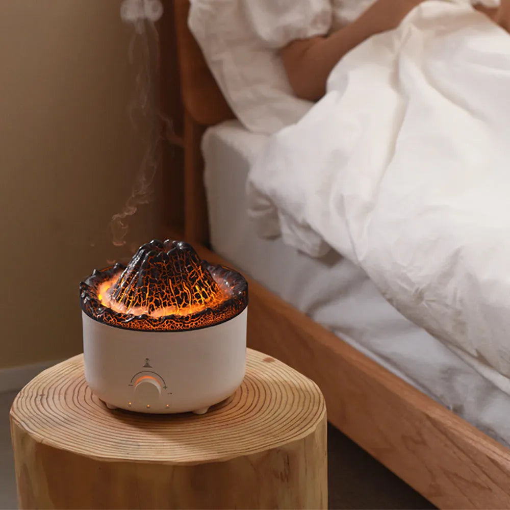 White simulated flame volcano humidifier with remote control showing orange and blue lighting effects