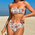 Close-up view of a women's printed bandeau swimsuit top and high-waisted shorts set laid flat.