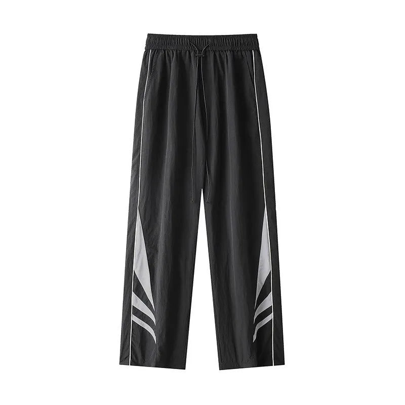 Men's straight-leg casual trousers in black, showing loose fit and button fly detail.