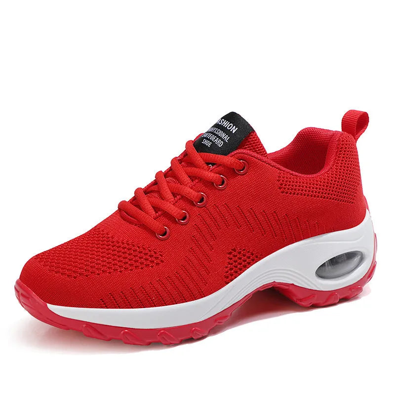 Red and black women's low-top mesh sneakers with round toe, front laces, and a mid heel on a white background.