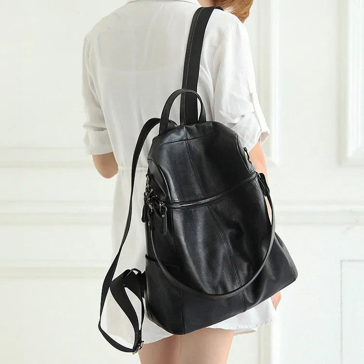 Genuine leather retro-style women's backpack showing front sandwich pocket and brown leather texture.