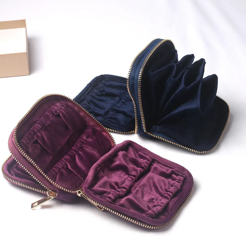 Blue PU zippered jewellery storage bag in handbag shape, 11x11x3.5cm, on a travel background