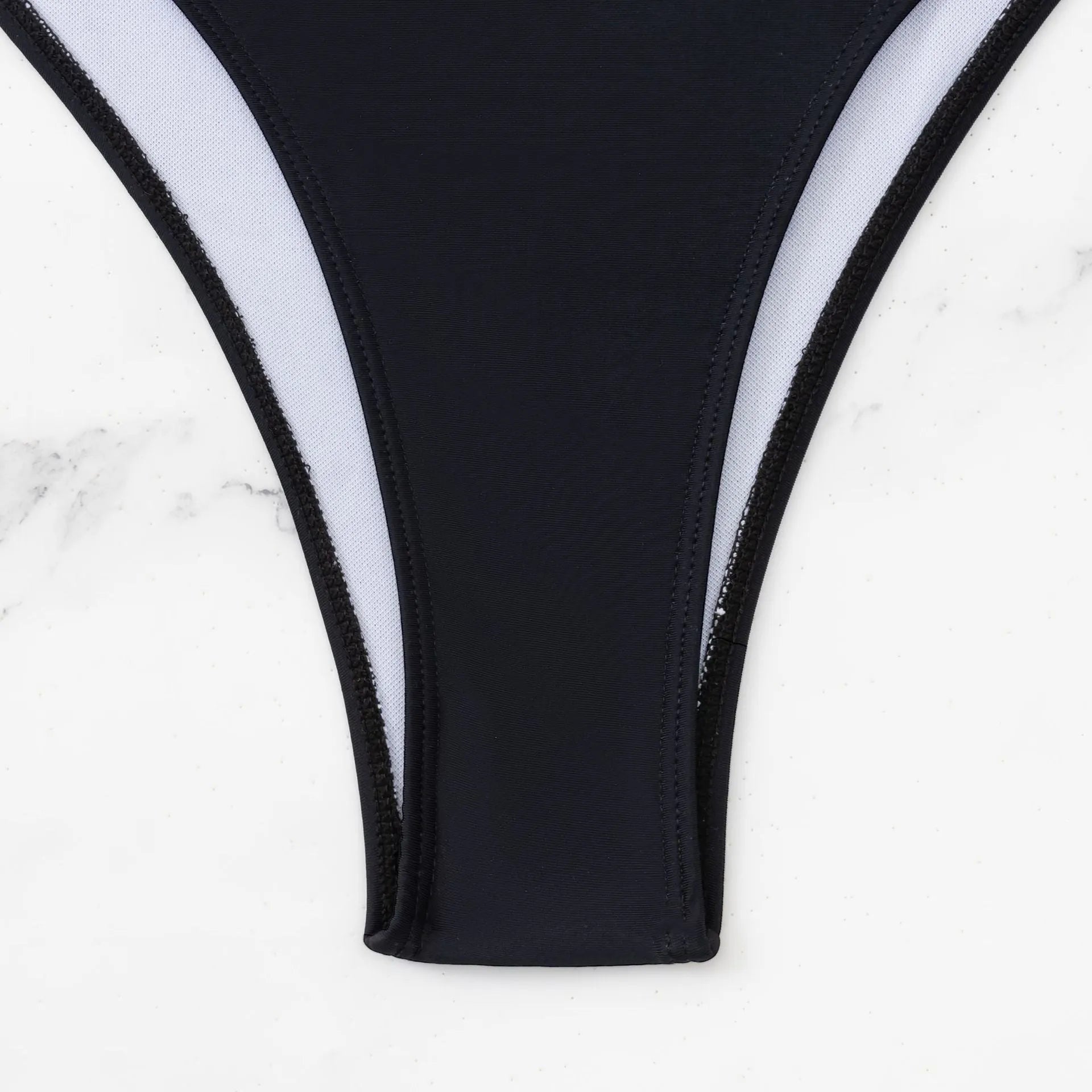 Black women's one-piece swimsuit with white contrast stitching and hollow detailing, sleeveless design.
