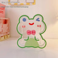 Clear square acrylic storage box with a cute illustrated strawberry rabbit design on a desk with pens.