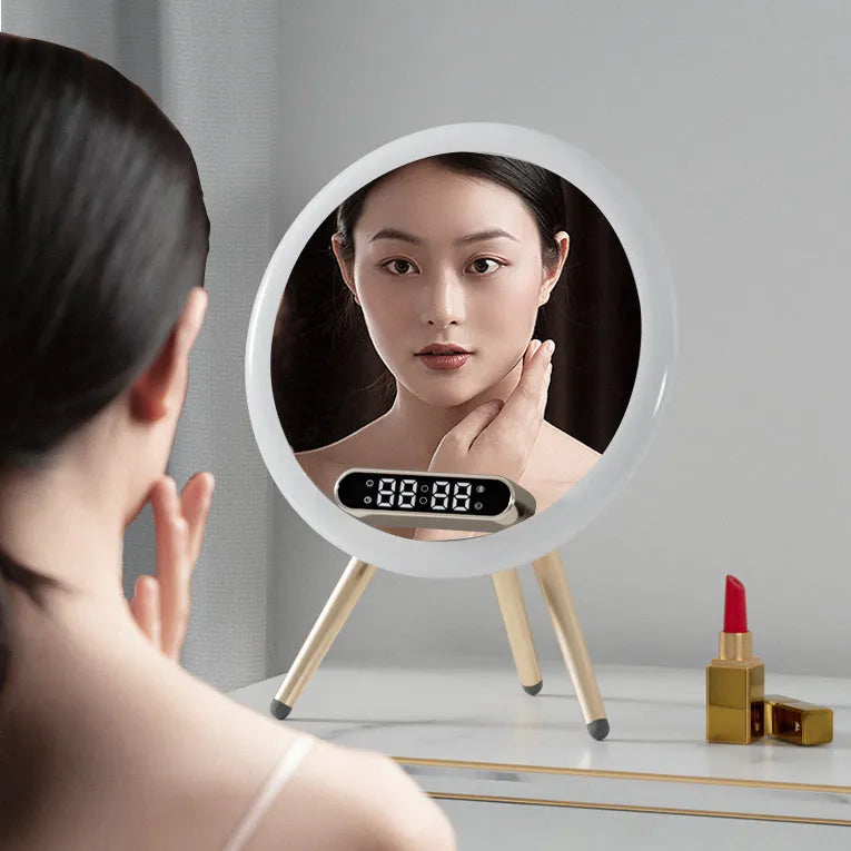 Multi-function LED mirror alarm clock with wireless charger and Bluetooth speaker in white colour on wooden desk