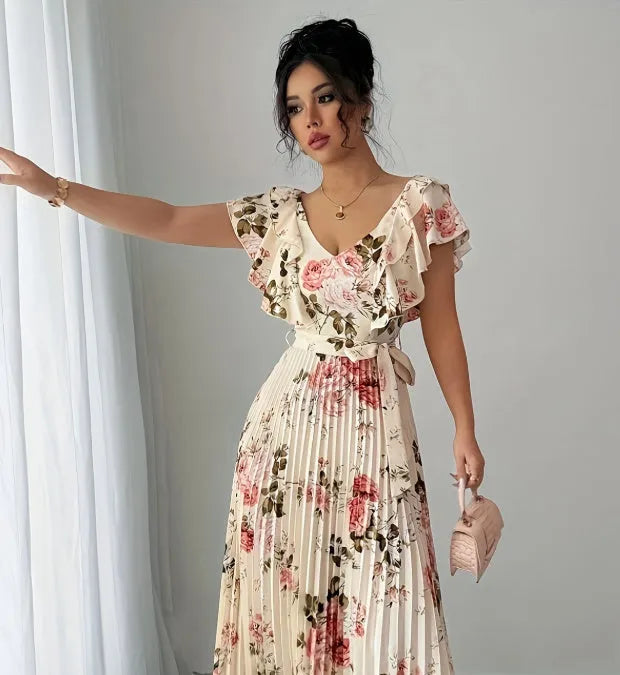 Apricot-coloured women's V-neck floral print dress with ruffled short sleeves and a long, pleated oversized swing skirt.