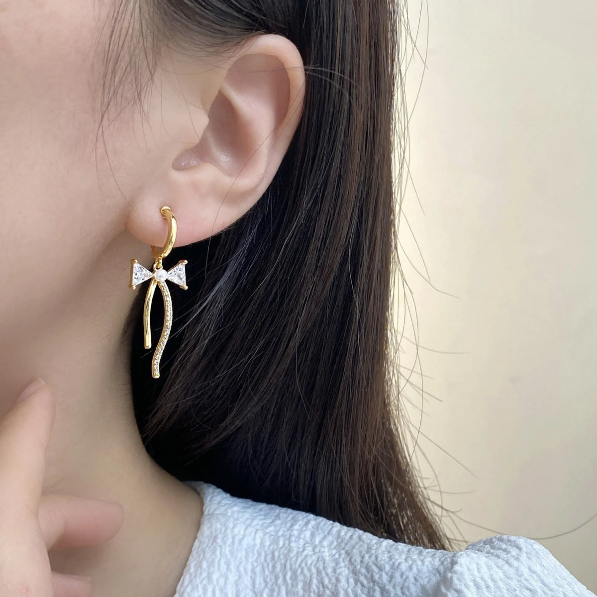 Asymmetric C-shaped copper earrings with inlaid zirconia stones, available as ear clips or ear studs for women.