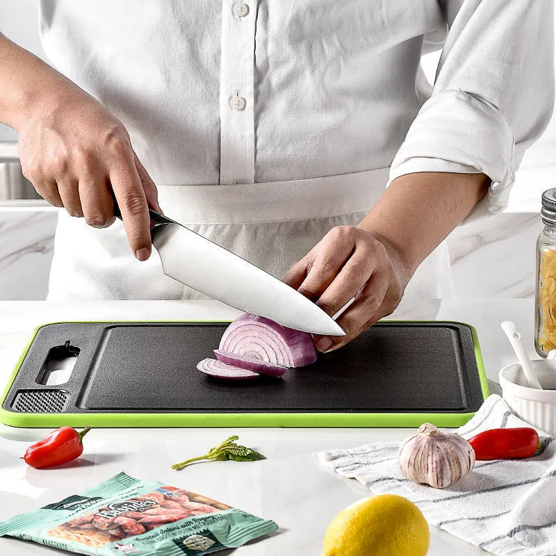 Grey square aluminium cutting board with double-sided design showing thawing surface and integrated knife sharpener
