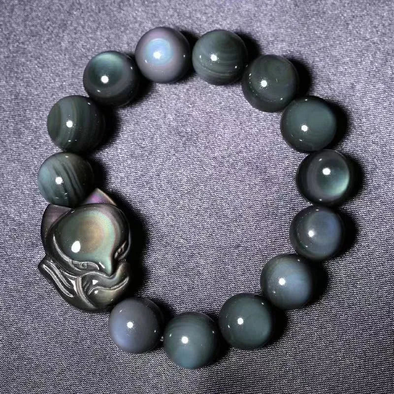 Obsidian stone bracelet with carved fox design in cartoon style, showing bead size options.