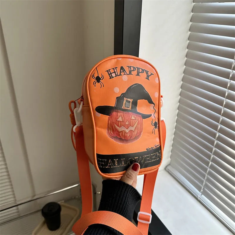 Black mini square crossbody bag with orange cartoon pumpkin, white ghost, and black bat graffiti print.