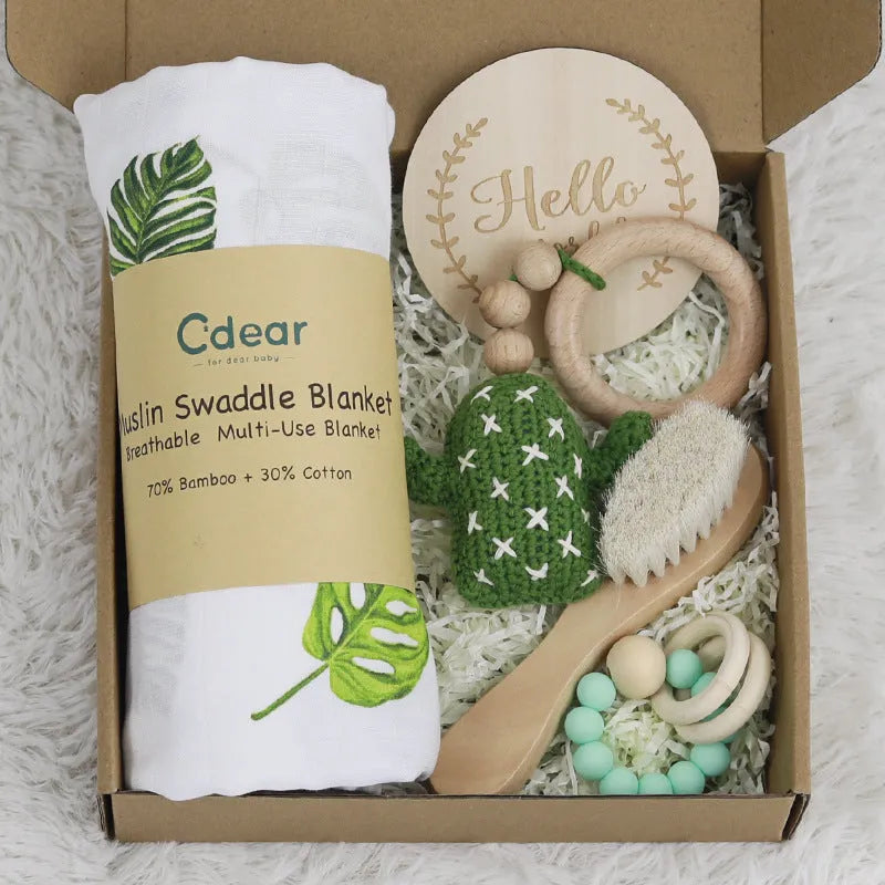 Baby teething gift set with bamboo gauze blanket, wooden chewing ring, woven bell, and developmental toys