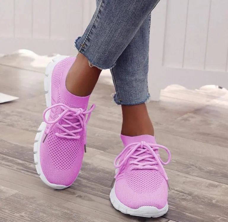 Women's casual flying knit mesh sports flat shoes in a light colour with front lace-up design.
