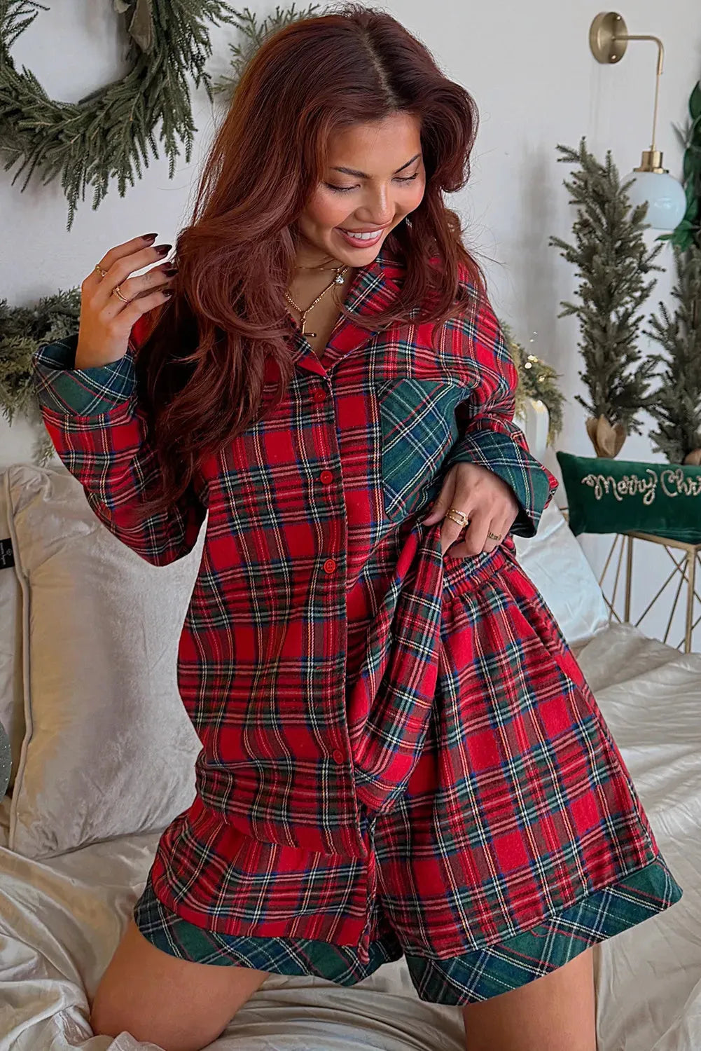 Red and black plaid Christmas pyjama set with contrast fabric patches on the shirt and matching shorts.