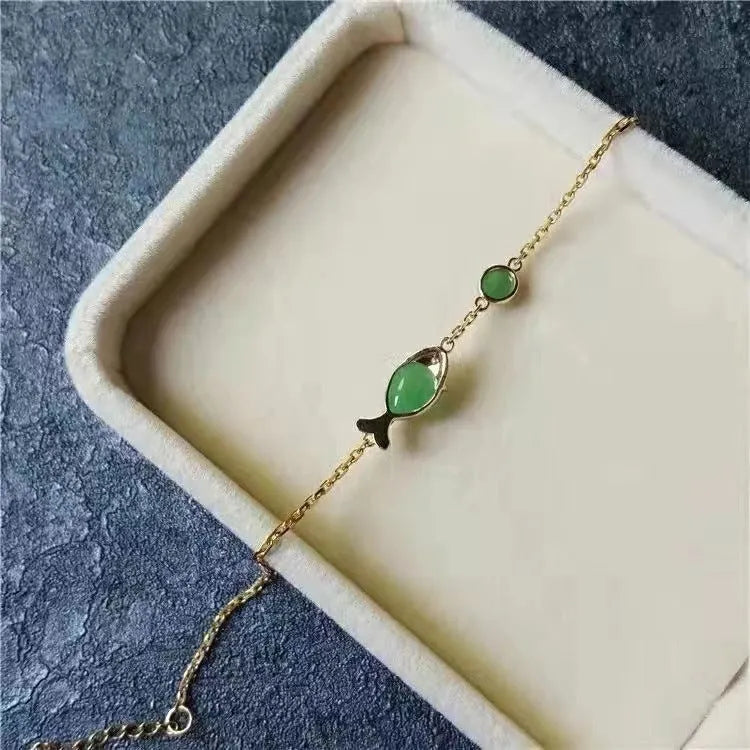 Yellow gold electroplated women's bracelet with retro style design on simple background