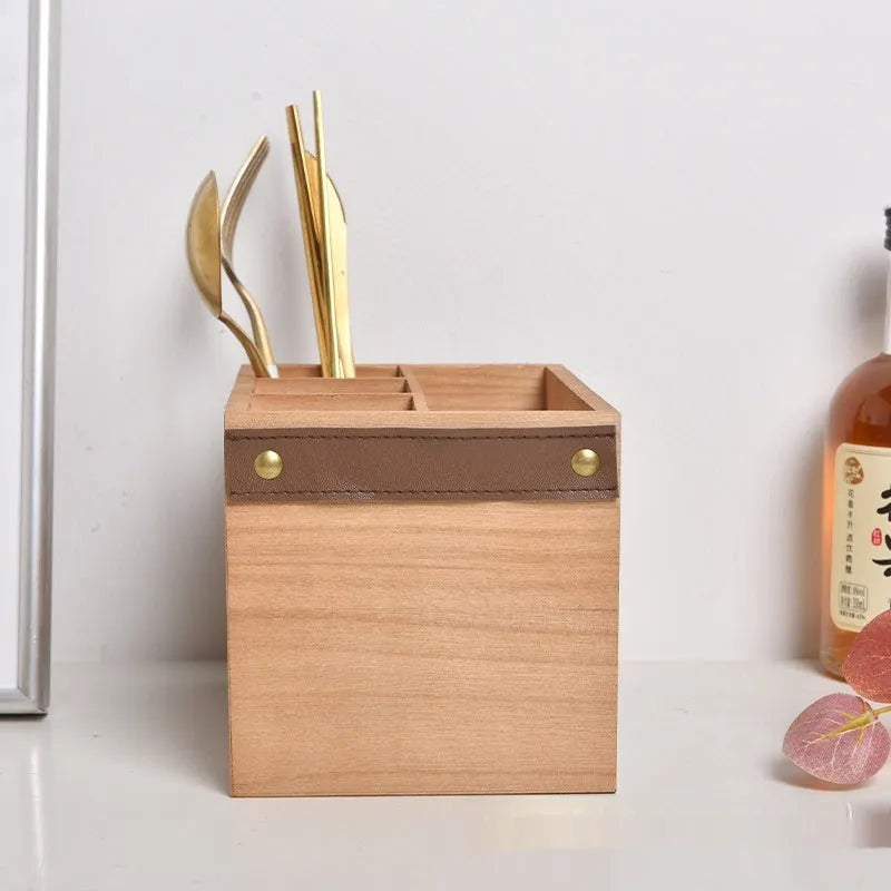 Wooden kitchen storage box with grid compartments for knives, forks, and chopsticks.