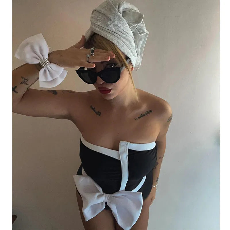 Women's black and white colour-blocking swimsuit with asymmetrical bow detail and tube top design