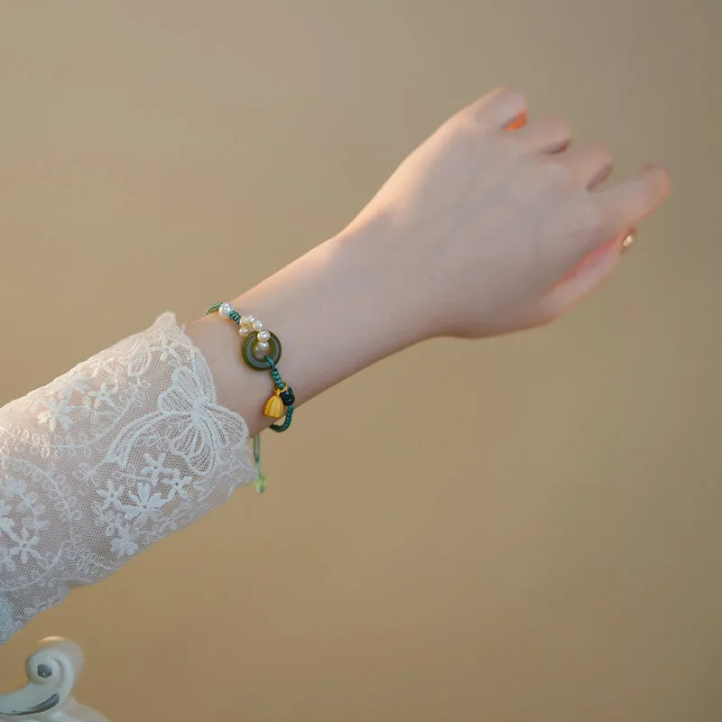 Hand-woven women's watch band with pearl details and a peace buckle in a retro style.