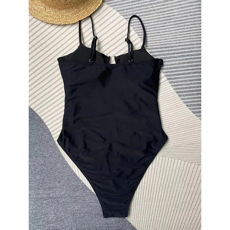 Black solid colour women's one-piece swimsuit on a hanger.