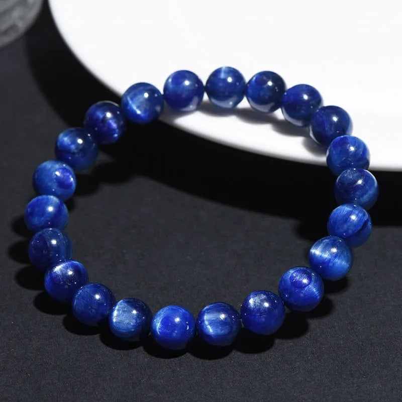Polished blue geometric crystal bracelet with Ruyi design elements on a wrist.
