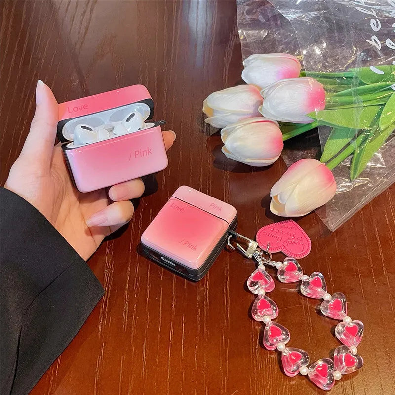 Soft TPU protective sleeve for AirPods 1/2 and Pro/3 in gradient pink, orange, or blue with love pendant.