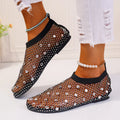 Colourful rhinestone detail on women's white mesh flat sandals with a rubber sole.