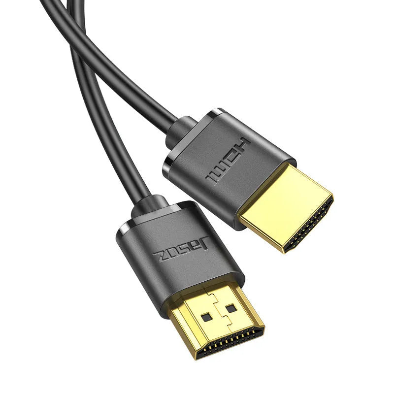 Gold-plated HDMI to HDMI cable with thin flexible wire on a white background.