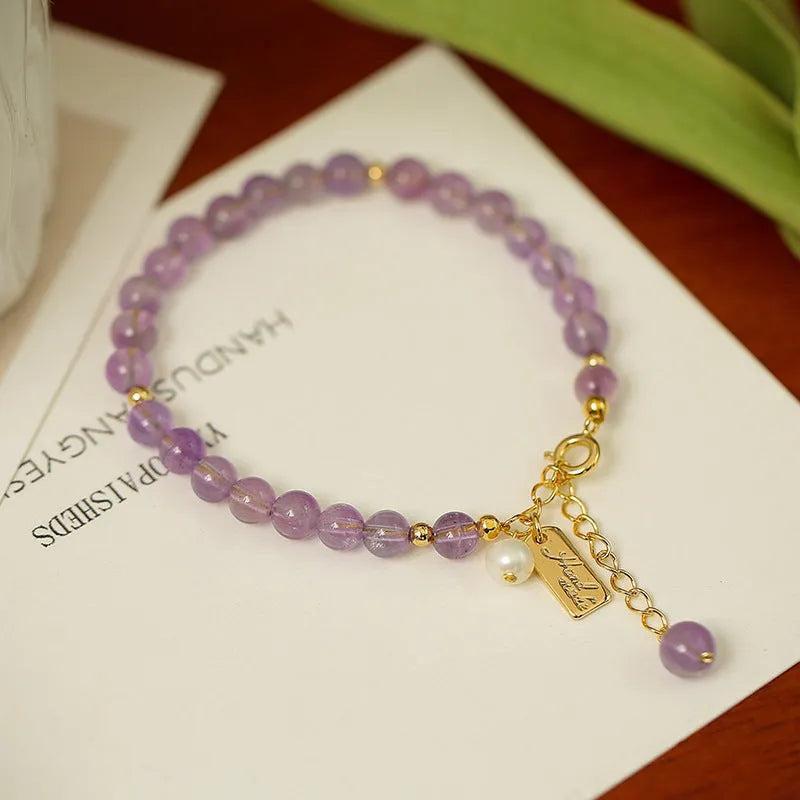 Women's lavender amethyst crystal bracelet with zodiac motif in dark and light colour options