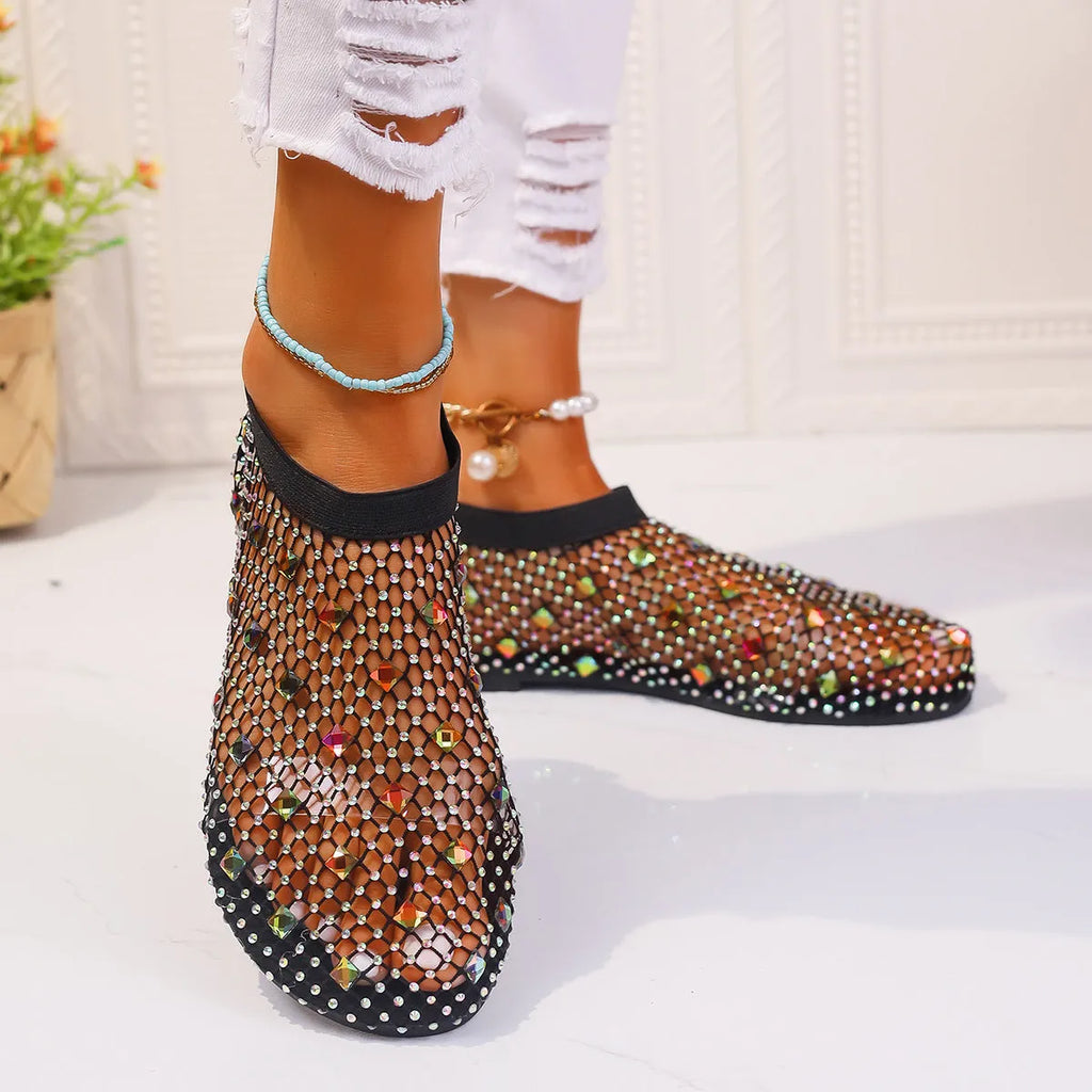 Colourful rhinestone detail on women's white mesh flat sandals with a rubber sole.