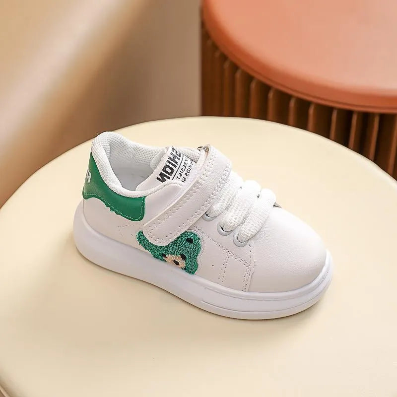 Children's black sports shoes with a cartoon bear design on the artificial leather upper and a rubber sole.