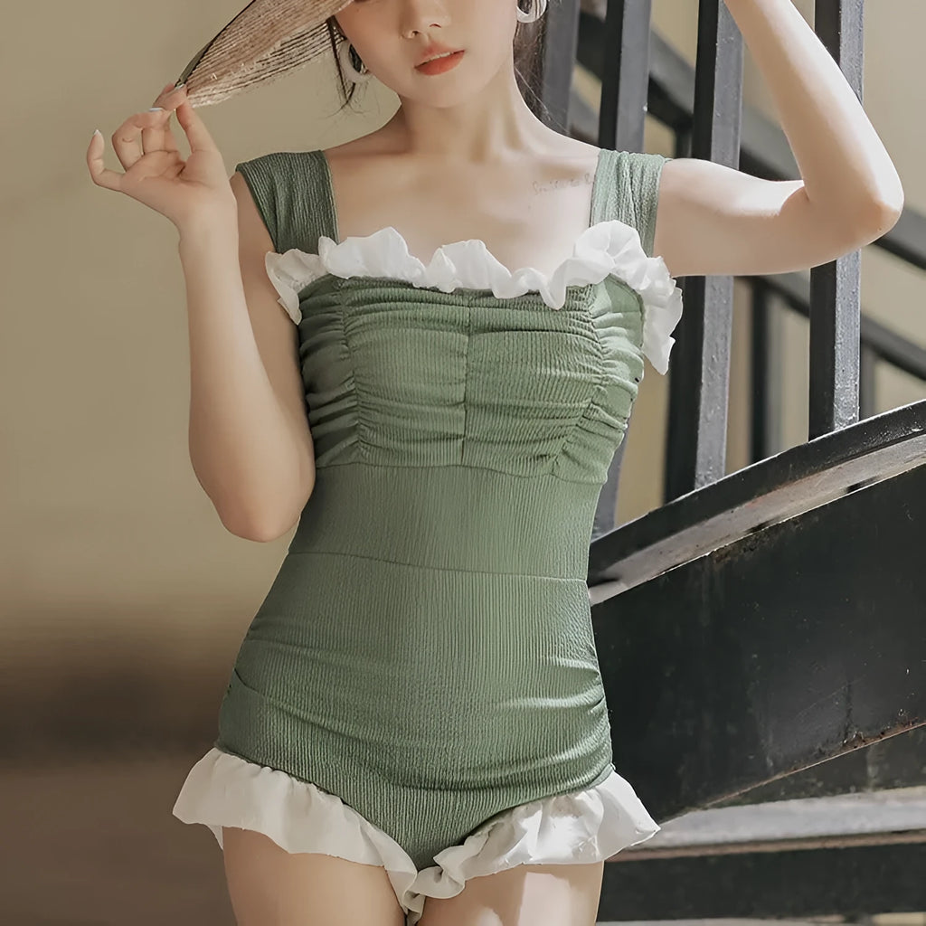 Black high-waisted one-piece swimsuit with triangle design on mannequin