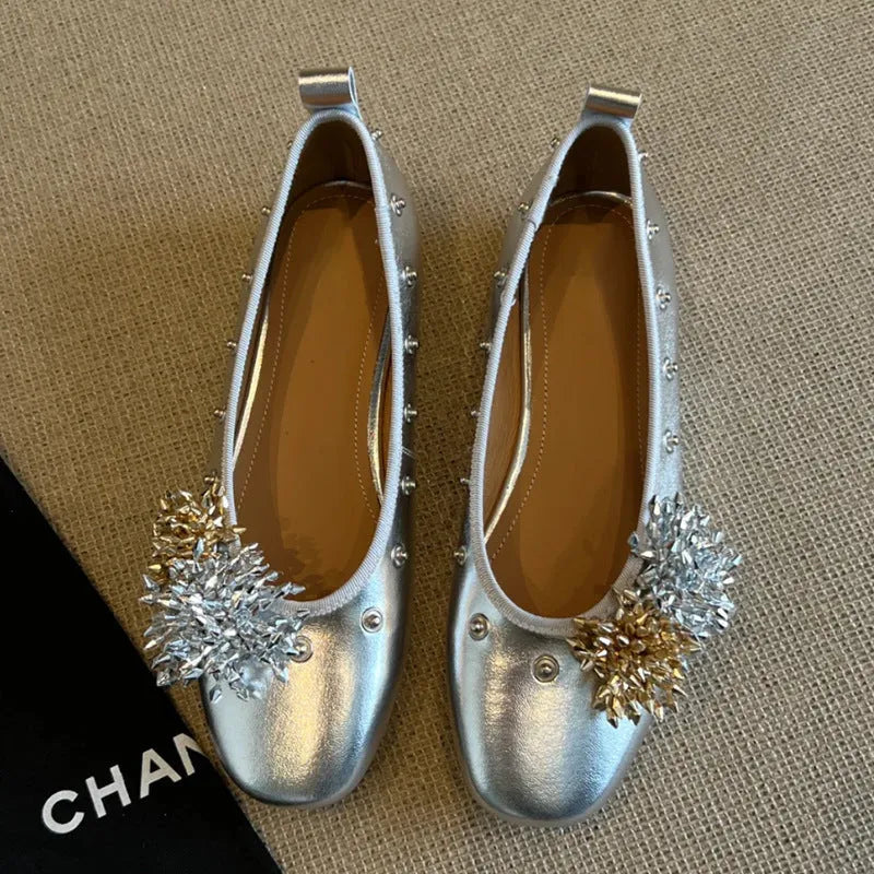 Silver Mary Jane buckle flats with DIY flower rivets on the strap, showing round toe and low top profile.