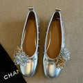 Silver Mary Jane buckle flats with DIY flower rivets on the strap, showing round toe and low top profile.