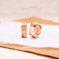 Rose gold women's earrings with a hollow heart shape featuring three cut-out sections.