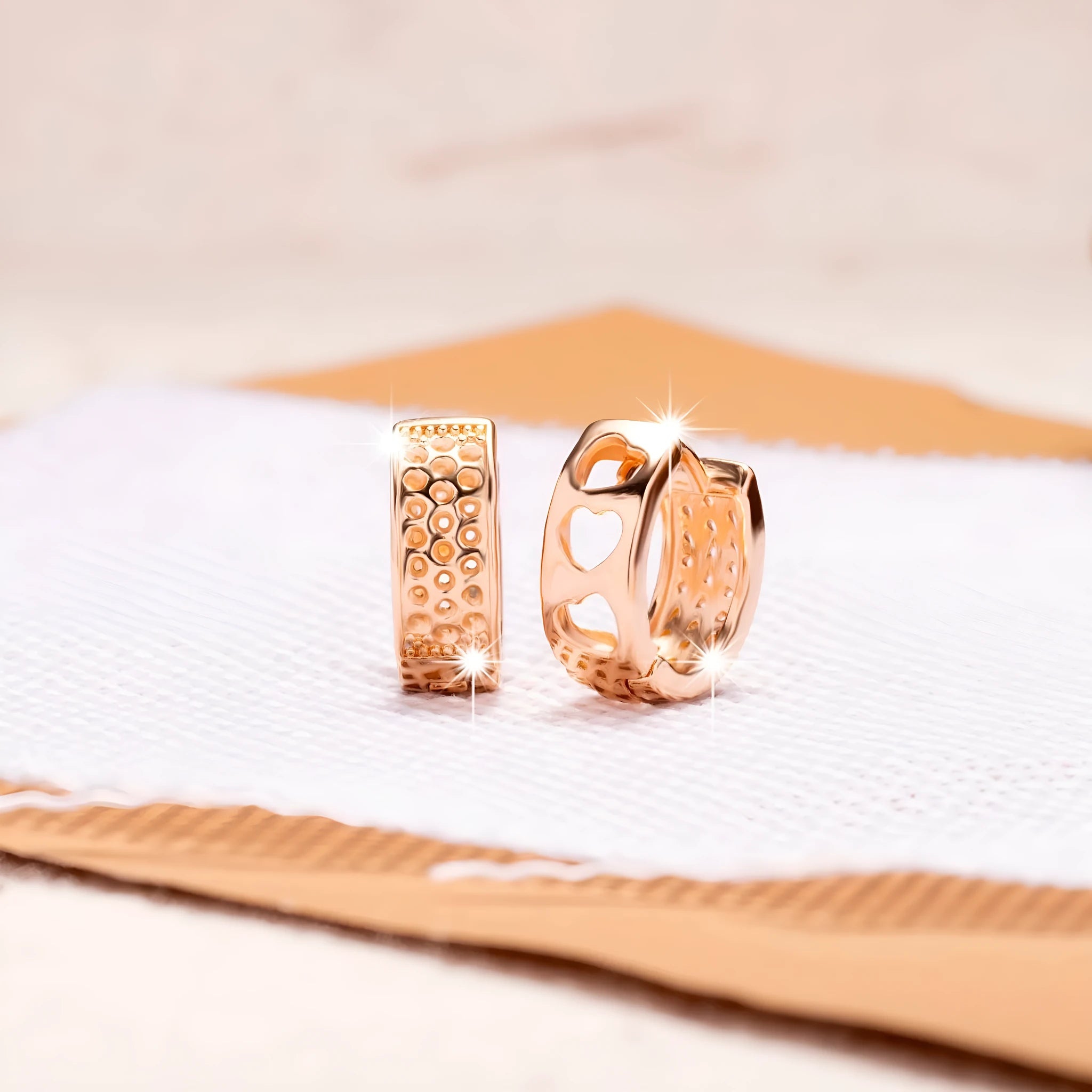 Rose gold women's earrings with a hollow heart shape featuring three cut-out sections.