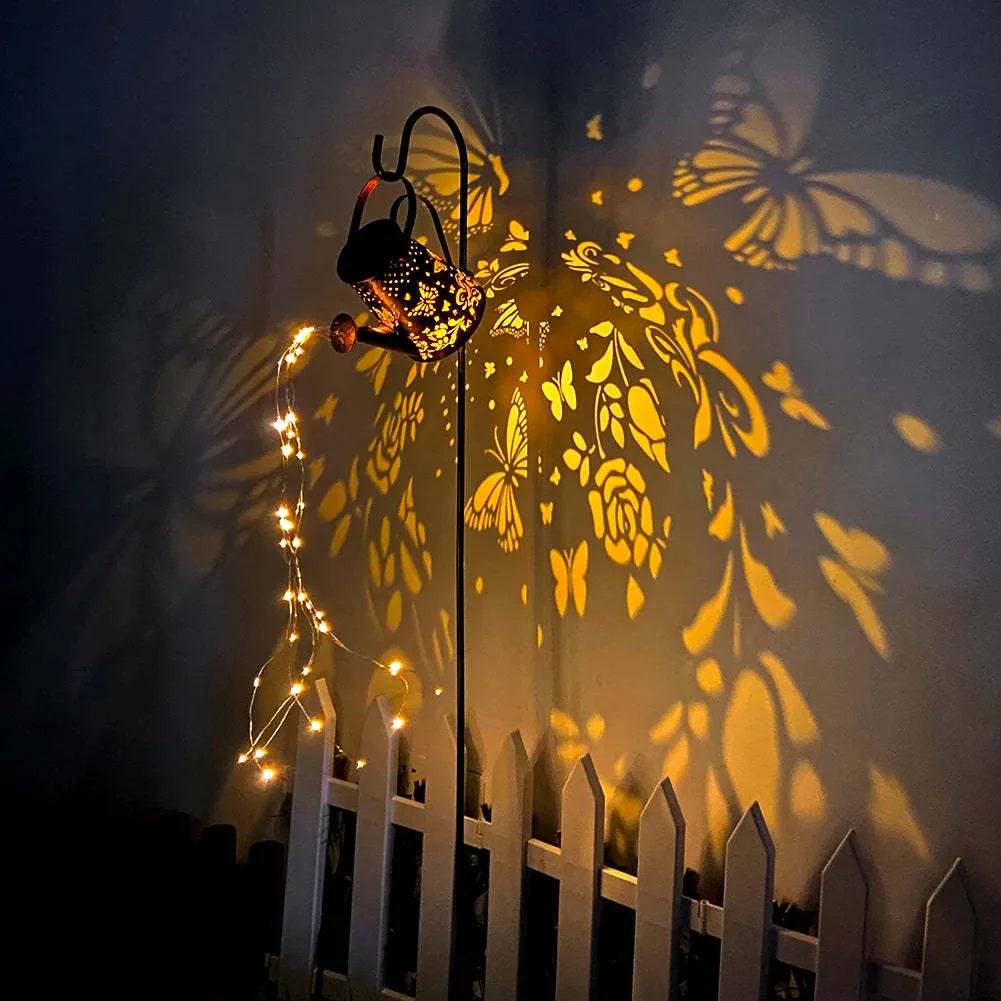 Solar-powered iron garden lamp with a tapered butterfly design emitting warm white light.