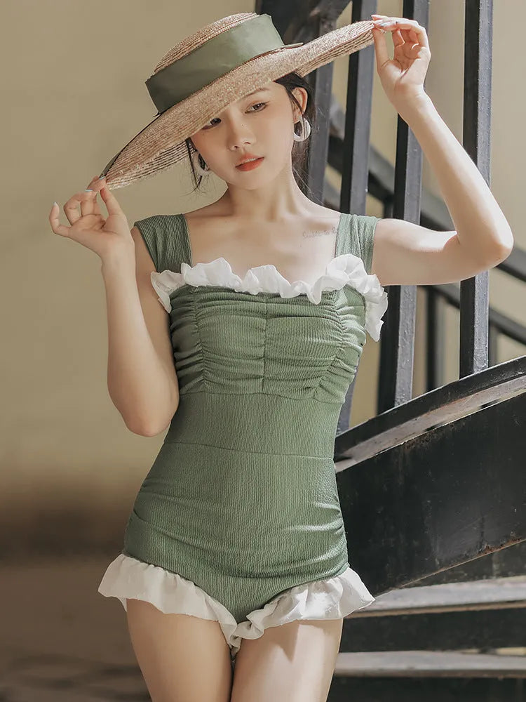 Black high-waisted one-piece swimsuit with triangle design on mannequin