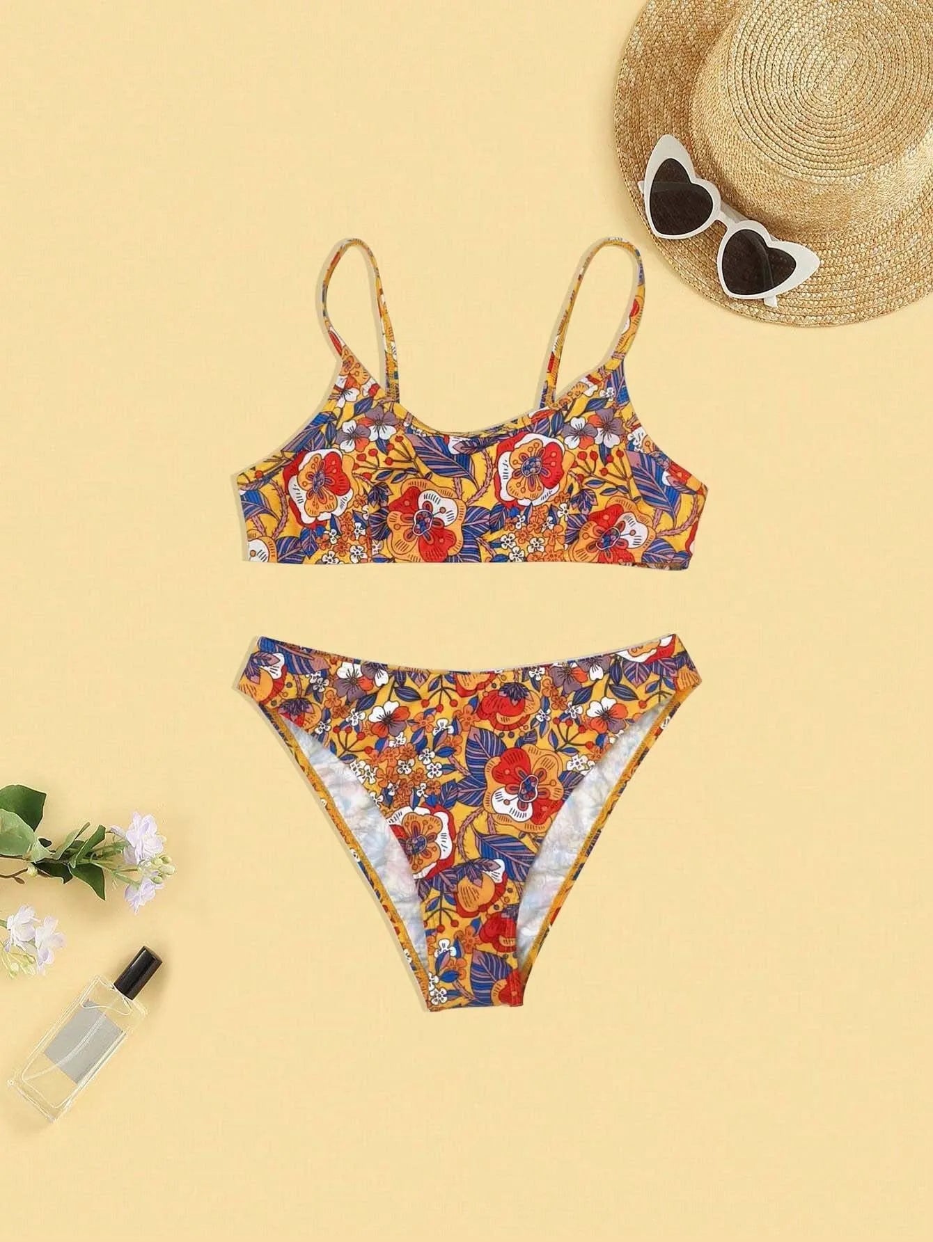 Plus size floral print strapped bikini swimsuit top and briefs on a white background.