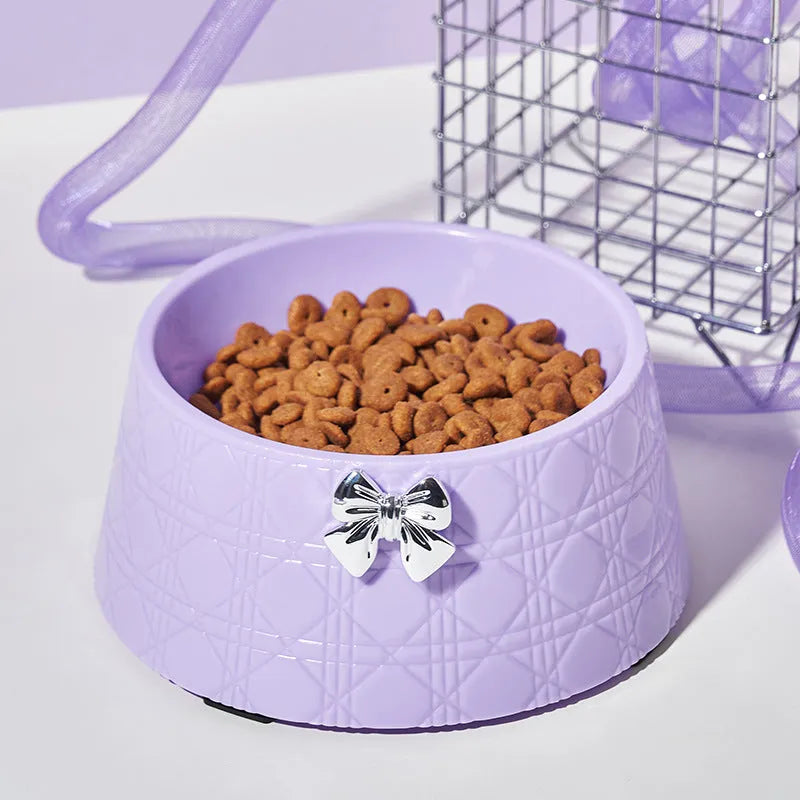 Ceramic pet bowl with diamond pattern and bowknot design in black, purple, and white options