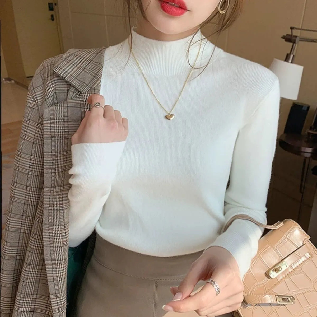 Slim fit knitted viscose bottoming shirt in apricot colour with long sleeves.