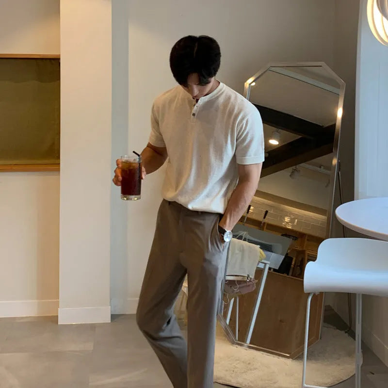 Man wearing a thin black short-sleeved knitted slim-fit pullover shirt.