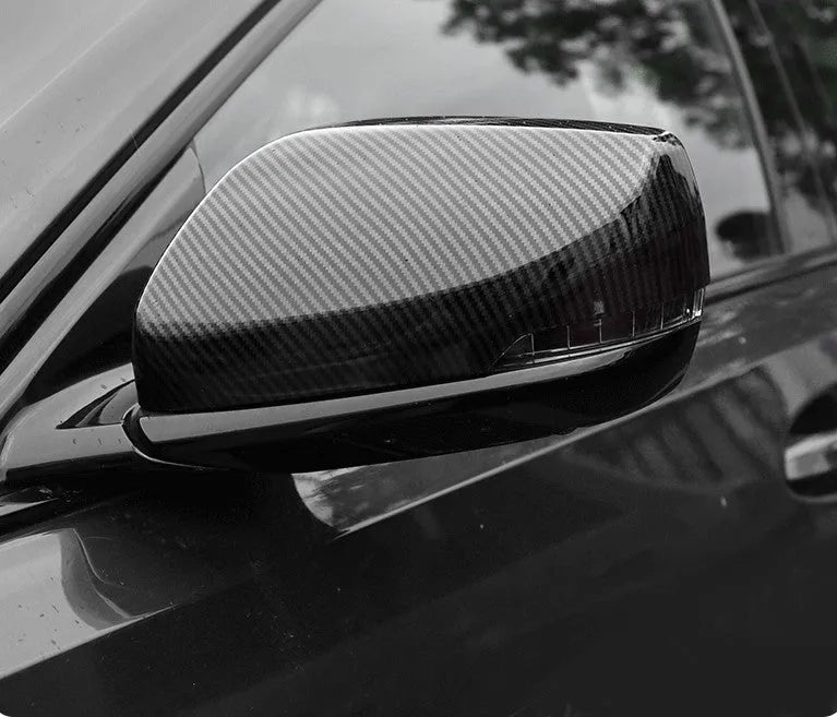 Set of ABS plastic mirror covers for Cadillac CT5 and CT6 in carbon fibre, silver, and rain frame finishes.