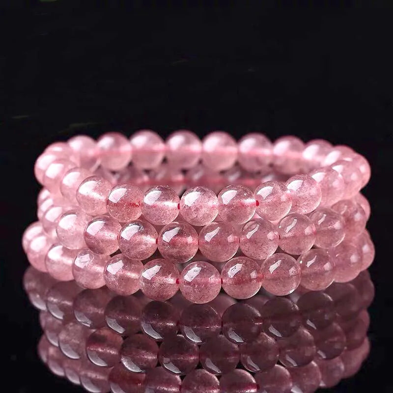 Women's strawberry quartz bracelet with polished beads in 6mm, 8mm, or 10mm sizes