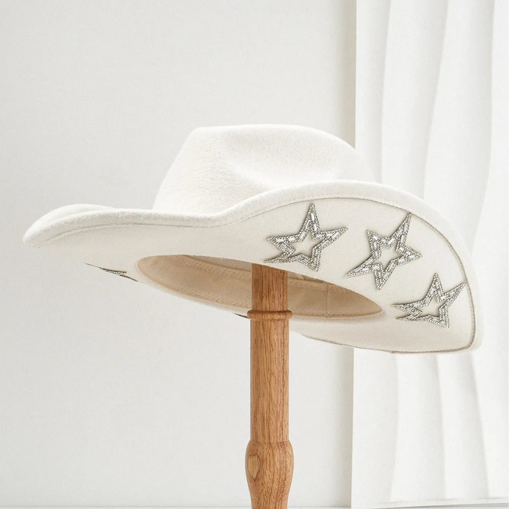 Beige woolen felt western denim top hat with a conical crown and a hexagonal star decoration on the front.