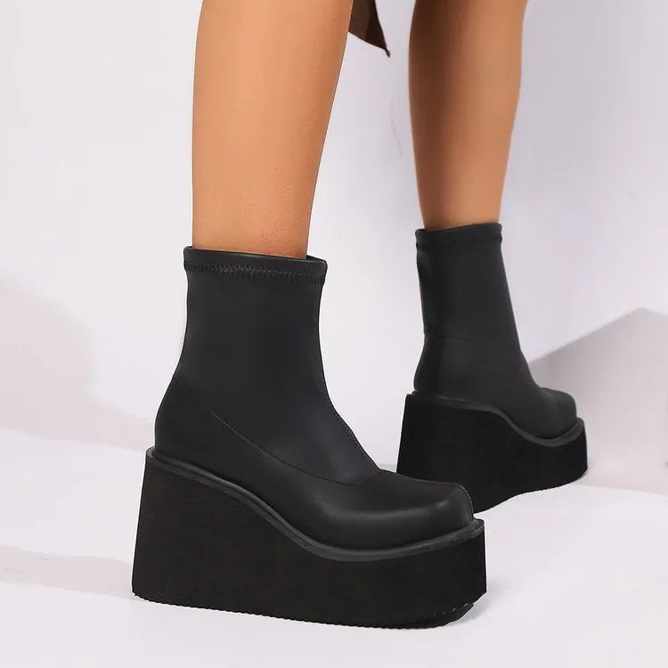 Plus size black women's wedge heel boots with a waterproof platform sole and round toe.