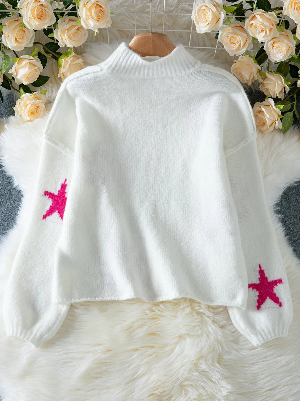 White women's loose turtleneck pullover with a thick imitation velvet texture and a five-pointed star pattern on the front.