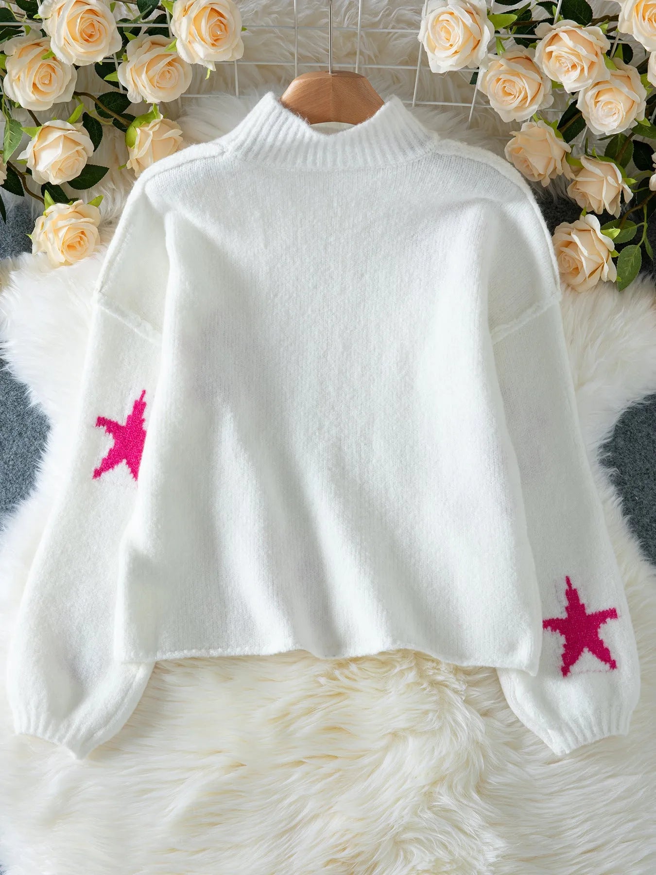 White women's loose turtleneck pullover with a thick imitation velvet texture and a five-pointed star pattern on the front.