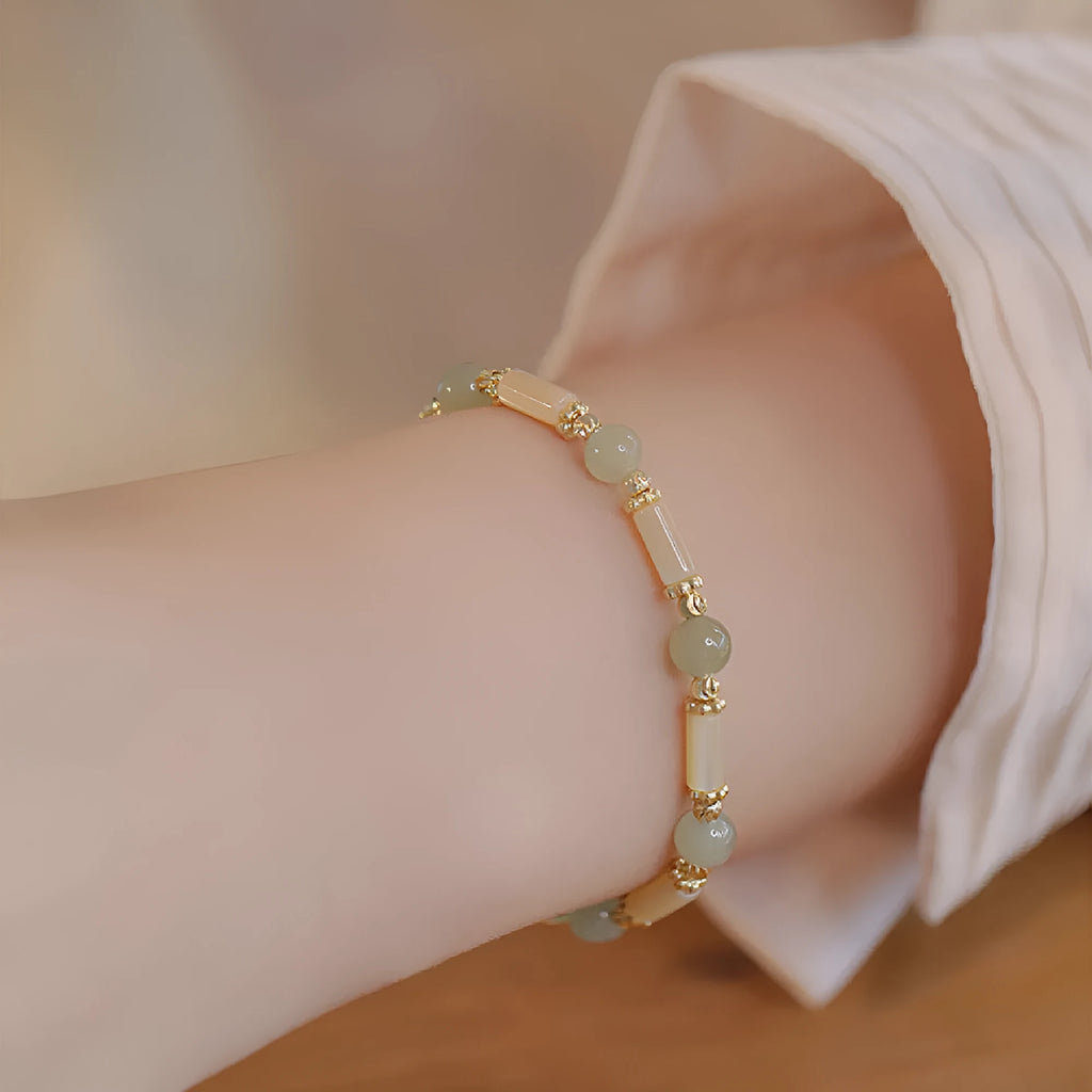 Women's green Hetian jade bracelet with a bamboo joint design.