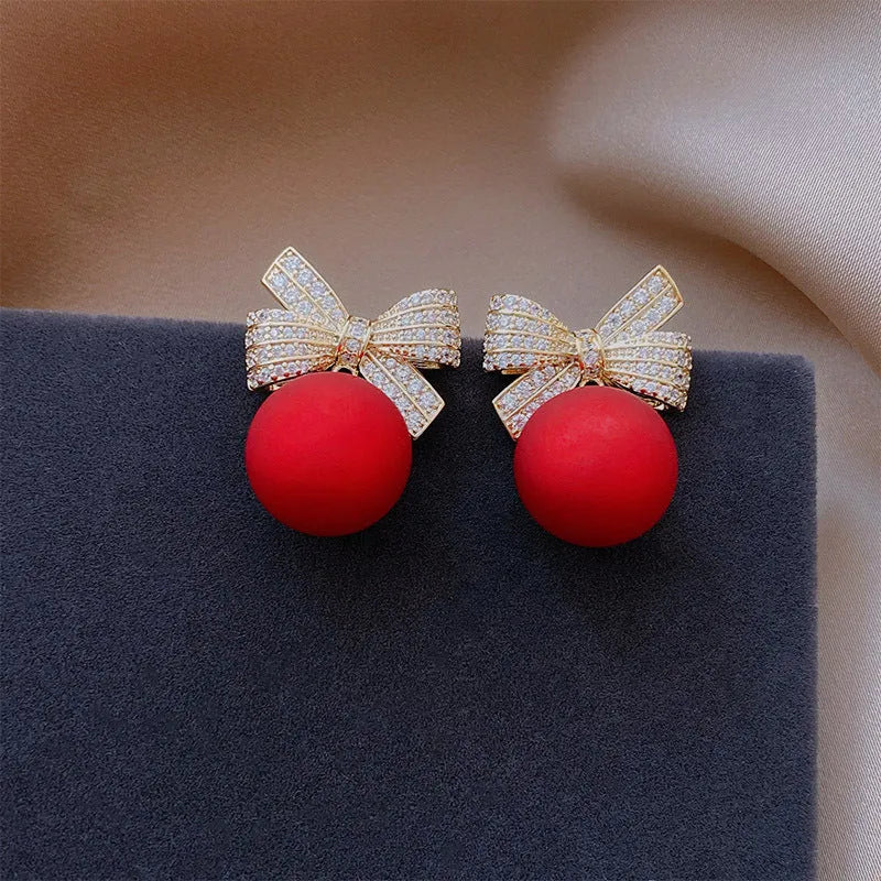 Women's bowknot stud earrings with rhinestone detail in Blue Pink Red White, alloy electroplated, individually packed.